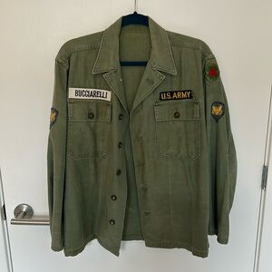 US Army surplus jacket with sewn on patches, fits a size M